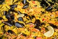 Close up of large portion of traditional Spanish paella dish freshly being cooked with seafood and rice in a frying pan at a stree Royalty Free Stock Photo