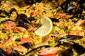 Close up of large portion of traditional Spanish paella dish freshly being cooked with seafood and rice in a frying pan at a stree Royalty Free Stock Photo