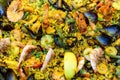 Close up of large portion of traditional Spanish paella dish freshly being cooked with seafood and rice in a frying pan at a Royalty Free Stock Photo