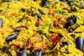 Close up of large portion of traditional Spanish paella dish freshly being cooked with seafood and rice in a frying pan at a Royalty Free Stock Photo