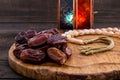 Close up of large premium dates on wooden board and rosary with