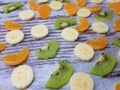 Close-up of a large round fruit candy on a background of slices of kiwi, mandarin Royalty Free Stock Photo