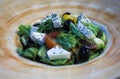 Close-up of a large round white-brown dish with Greek salad with cheese, vegetables, lettuce Royalty Free Stock Photo