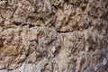 Close up Textured background of a wall of medieval stone masonry. The wall is sloppy built of mountain stones. Medieval Royalty Free Stock Photo