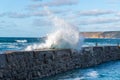 Close up of a large wave breaching the harbour wall at Sennen, Cornwall Royalty Free Stock Photo