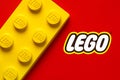 Close up of large yellow lego block with the Lego logo. Illustrative editorial