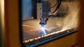 Laser cutting machine etching patterns into metal with a focus-beam vaporizing metal Royalty Free Stock Photo