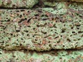 Close up of Laterite stone block wall with green moss growth beautiful patterns Royalty Free Stock Photo