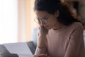 Woman reading letter feels upset by debt or financial problems Royalty Free Stock Photo