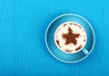 Close up latte cappuccino coffee in cup on blue Royalty Free Stock Photo