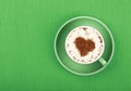 Close up latte cappuccino coffee in cup on green Royalty Free Stock Photo