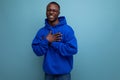close-up of a laughing black american man in a sweatshirt with a hood on a studio background with copy space Royalty Free Stock Photo