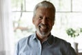 Close up laughing elderly grey haired man looking at camera Royalty Free Stock Photo