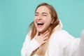 Close up of laughing young woman girl in casual white hoodie isolated on blue turquoise background. People lifestyle Royalty Free Stock Photo