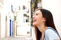 Close up laughing young woman standing on city street Royalty Free Stock Photo