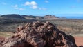 Close up of lava stone. Volcanic landscape in the background.