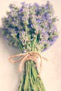 Close up of lavender bouquet over a white wood background. Vintage style.