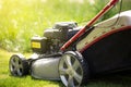 Close up of lawn mower on the grass, ready for cutting the grass in the garden, gardening concept, copy space Royalty Free Stock Photo