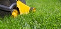 Close-up of a lawn mower on green lawn grass Royalty Free Stock Photo