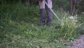 Close-up of a lawn mower man mowing grass Royalty Free Stock Photo