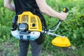Close-up of a lawn mower with a petrol trimmer, focus is on engine Royalty Free Stock Photo