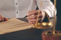 Close up lawyer businessman working or reading lawbook in office workplace.