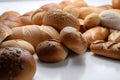 close up lay flat of breads scattered on a white work surface