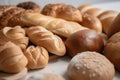 close up lay flat of breads scattered on a white work surface , shot from above even daylight ligting, strong focus good detail