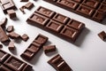 close up lay flat of chocolate bar scattered on a white work surface