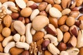 close up lay flat of mixed nuts scattered on a white work surface