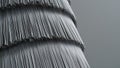 Close up of layered silver metallic fringe against gray background texture Royalty Free Stock Photo