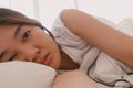 Close up of lazy Asian woman just wake up but not get up from the bed.