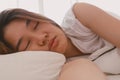 Close up of lazy Asian woman just wake up but not get up from the bed.