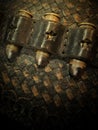 Close-up of a leather gun belt holding three .45 Colt long antique bullets