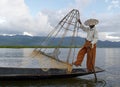 Close up of leg-rowing fisherman holding net, Inle Lake, Myanmar