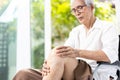 Close up,Leg of senior aged having pain in her knee,massage the kneecap with hands,joint disease,asian old elderly suffered severe Royalty Free Stock Photo