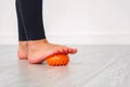 Close-up of a leg in sportswear with a massage ball. Heel pressure on the ball