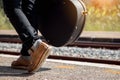 Close up leg of traveler with guitar case at railway station