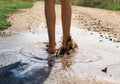 Close-up of a leg walking happily through the warm summer puddl Royalty Free Stock Photo