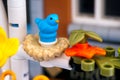 Close-up of Lego blue bird in a nest on a tree