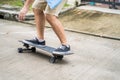 Close up a legs of active Asian hipster guy ride Surf Skate Board on street in front of his house. Extreme sport man skater enjoy