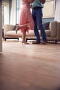 Close Up On Legs As Romantic Senior Retired Couple Dancing In Lounge At Home Together Royalty Free Stock Photo