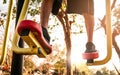 Close up Legs of Asian senior man in sporty clothes exercising for good health on outdoor fitness equipment in a public park on