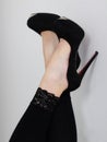 Close up of legs and black high heels touch the wall Royalty Free Stock Photo