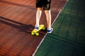 Close up legs in blue sneakers riding on yellow skateboard in motion. Active urban lifestyle of youth, training, hobby, activity