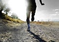 Close up legs and feet of extreme cross country man running and training on rural track jogging at sunset Royalty Free Stock Photo