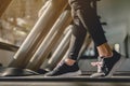 Close-up Legs and feet of women walking on the treadmill in the gym for good health and strength at sunset.