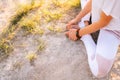 Close-up of legs and hands of young woman meditating sitting in lotus position with closed eyes. Royalty Free Stock Photo
