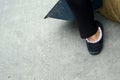 Close up of legs of maid with a broom and a dustpan on concrete floor Royalty Free Stock Photo