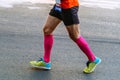 close-up legs male runner in pink compression socks Royalty Free Stock Photo